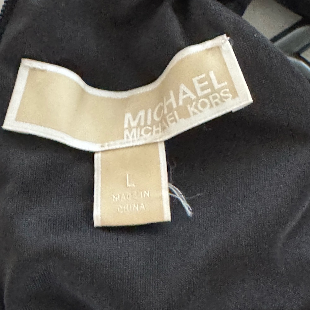 Black woman Michael Kors jumpsuit.